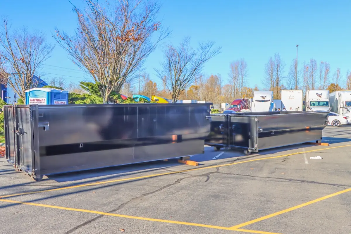 Professional dumpster rental service with roll-off container on residential driveway in Durant